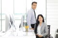 Two Asain businessman and businesswoman relaxing together in off Royalty Free Stock Photo