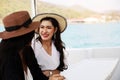 Two Asia woman traveling for relaxation and drinking wine on speed boat at Thailand. Royalty Free Stock Photo