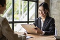 Two asian accountants brainstorming financial charts a financial advisor or analyst