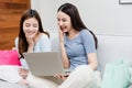 Two Asian beauty people are using a credit card to make purchases using a laptop via the internet. With a happy smiling face, Royalty Free Stock Photo