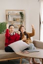 Two asian beauty smiling young women sitting on sofa Attractive casual girl feel happy and relax,having fun watch comedy video on Royalty Free Stock Photo
