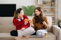 Two asian beauty smiling young women sitting on sofa Attractive casual girl feel happy and relax,having fun watch comedy video on Royalty Free Stock Photo