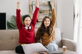 Two asian beauty smiling young women sitting on sofa Attractive casual girl feel happy and relax,having fun watch comedy video on Royalty Free Stock Photo