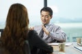 Two asian business people having a discussion in office Royalty Free Stock Photo