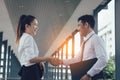 Two asian business people standing and shaking hands with together Royalty Free Stock Photo