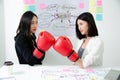 Two asian business women fight. Angry women, looking at each other with hatred, blaming for problem. Friendship difficulties, Royalty Free Stock Photo