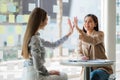 Two Asian businesswomen discussed their ideas at a meeting. Two people discuss working on investment projects and planning strateg Royalty Free Stock Photo