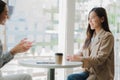 Two Asian businesswomen discussed their ideas at a meeting. Two people discuss working on investment projects and planning strateg Royalty Free Stock Photo