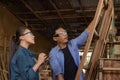 Two asian carpenters in a construction workshop. business man and woman working together woodwork