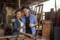 Two asian carpenters in a construction workshop. business man and woman working together woodwork