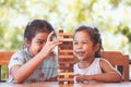 Two asian child girl playing wood blocks stack game together