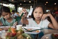 Two asian child girls eating delicious fried fish and salad in the restaurant Royalty Free Stock Photo