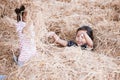 Two asian child girls having fun to play with hay stack together Royalty Free Stock Photo