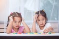 Two asian child girls having fun to play and learn magnetic alphabet Royalty Free Stock Photo