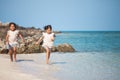 Two asian child girls having fun to play and run on beach together in summer vacation Royalty Free Stock Photo