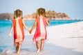 Two asian child girls holding hand each other and walking together on beach near the sea in summer vacation Royalty Free Stock Photo