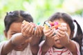 Two asian child girls holding sweet candies in thier hands Royalty Free Stock Photo