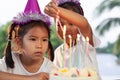 Two asian child girls lighting candle on birthday cake together in birthday party Royalty Free Stock Photo