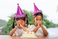 Two asian child girls make folded hand to wish the good things for their birthday Royalty Free Stock Photo