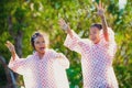 Two asian child girls wearing raincoat having fun to play with bubbles together after rainy Royalty Free Stock Photo