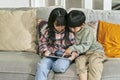 two asian children playing computer game using digital tablet Royalty Free Stock Photo