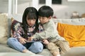two asian children playing computer game using digital tablet Royalty Free Stock Photo