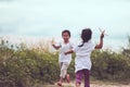 Two asian children playing with toy paper airplane