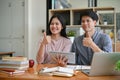 Two Asian college students are showing their thumbs up while studying Royalty Free Stock Photo