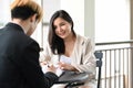 Two corporate businesspeople discussing business while sitting on a terrace outside office. Royalty Free Stock Photo