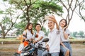 Two asian couple high school students selfie sitting on motorbike