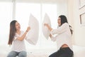 Two Asian doing pillow fight in bedroom. Lifestyles and People concept. Relation and friendship theme