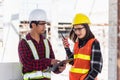 Two Asian engineer foreman architect worker man and woman talking at building construction site Royalty Free Stock Photo