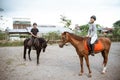 two asian equestrian athletes meet during equestrian practice