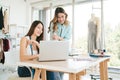 Two Asian female fashion designers or dressmakers brainstormed and discuss the design of the new collection. Royalty Free Stock Photo