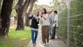 Two Asian female students best friends are enjoying talking while walking, going to school together Royalty Free Stock Photo