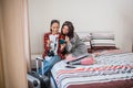 two Asian female travelers check tickets and passports on a bed