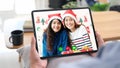 Two asian girl video call to family for greeting in Christmas celebration, Hand holding digital tablet while talking with daughter