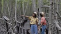 Two Asian girl walking at mangrove forest at Pranburi Prachuap Khiri Khan Thailand Royalty Free Stock Photo