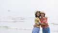 Two asian girl wear colorful shirt in happy emotion at beach Royalty Free Stock Photo