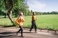 two Asian girls in headscarves enjoy jogging together while chatting in the afternoon Royalty Free Stock Photo