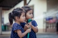 Two asian girls helping parent washing a car Royalty Free Stock Photo