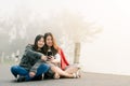 Two asian girls Very close friends Wearing a sweater, take a selfie phone, take pictures in a tourist attraction Along the road Royalty Free Stock Photo