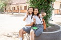 two asian high school girls selfie with v hand gesture