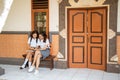 two asian high school girls sitting outside the classroom Royalty Free Stock Photo