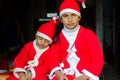 Two Asian Indian Ethnicity kids wearing Santa Hat waving having Royalty Free Stock Photo