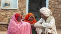 Two Asian Indian Women and Man In Conversation