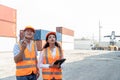 two asian industrial engineer man and woman wearing safety vest and helmet. Foreman talking with worker or laborer in the Royalty Free Stock Photo