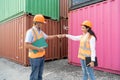 two asian industrial engineer man and woman wearing safety vest and helmet. Foreman talking with worker or laborer in the Royalty Free Stock Photo