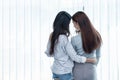 Two Asian Lesbian women looking together in bedroom. Couple people and Beauty concept. Happy lifestyles and home sweet home theme