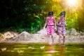Two asian little child girls playing paper boat in the riverside Royalty Free Stock Photo